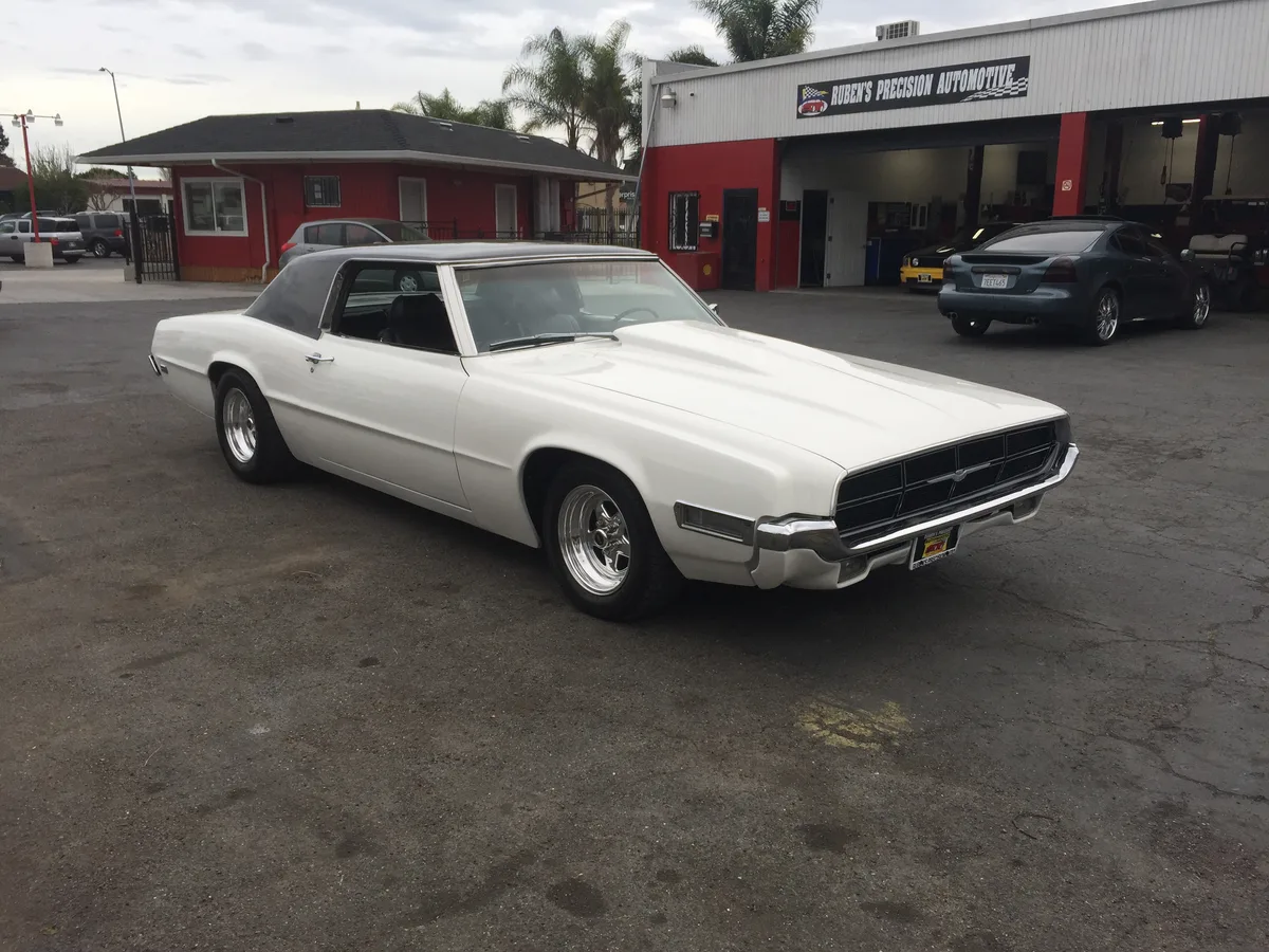 White Thunderbird with custom wheels at the shop