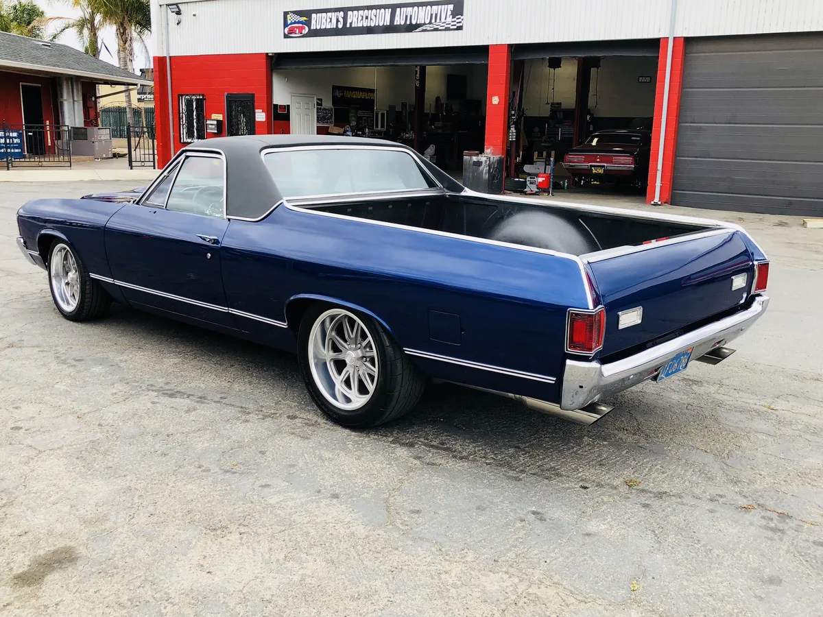 Dark blue classic convertible pickup truck at the shop